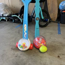 two infant push toys: a Fisher-Price Corn Popper and a B. Play Ball Popper & Walke