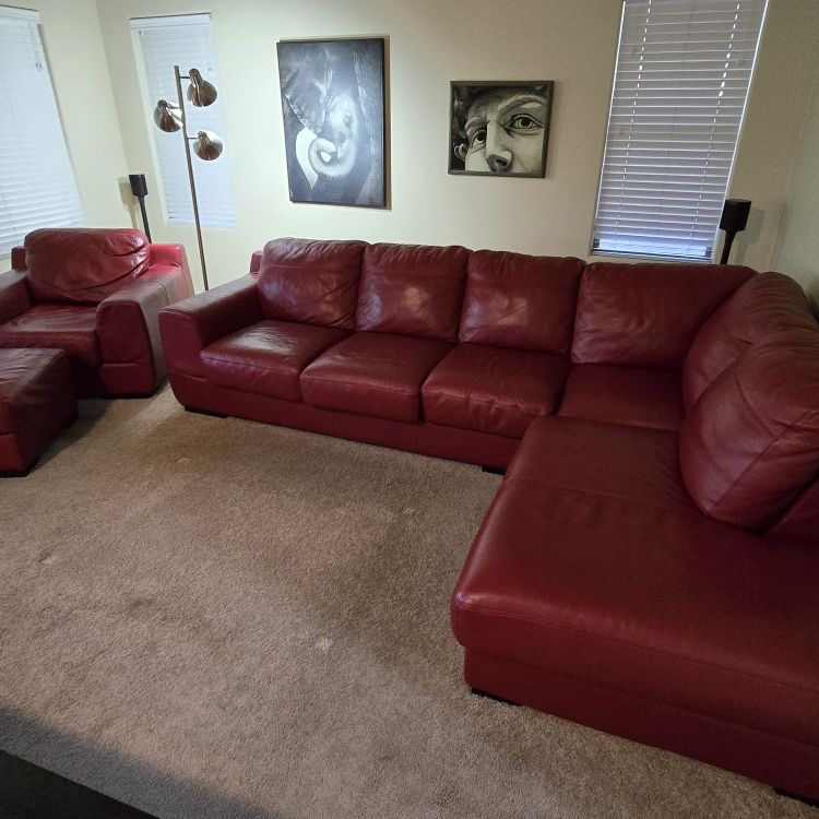 Red leather sectional with chair and ottoman