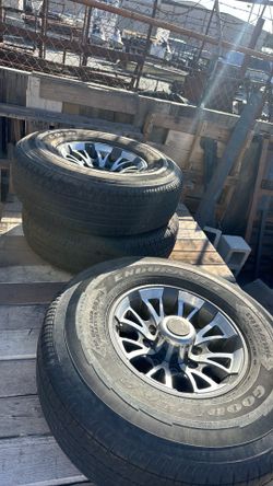 Set of four trailer wheels and tires.