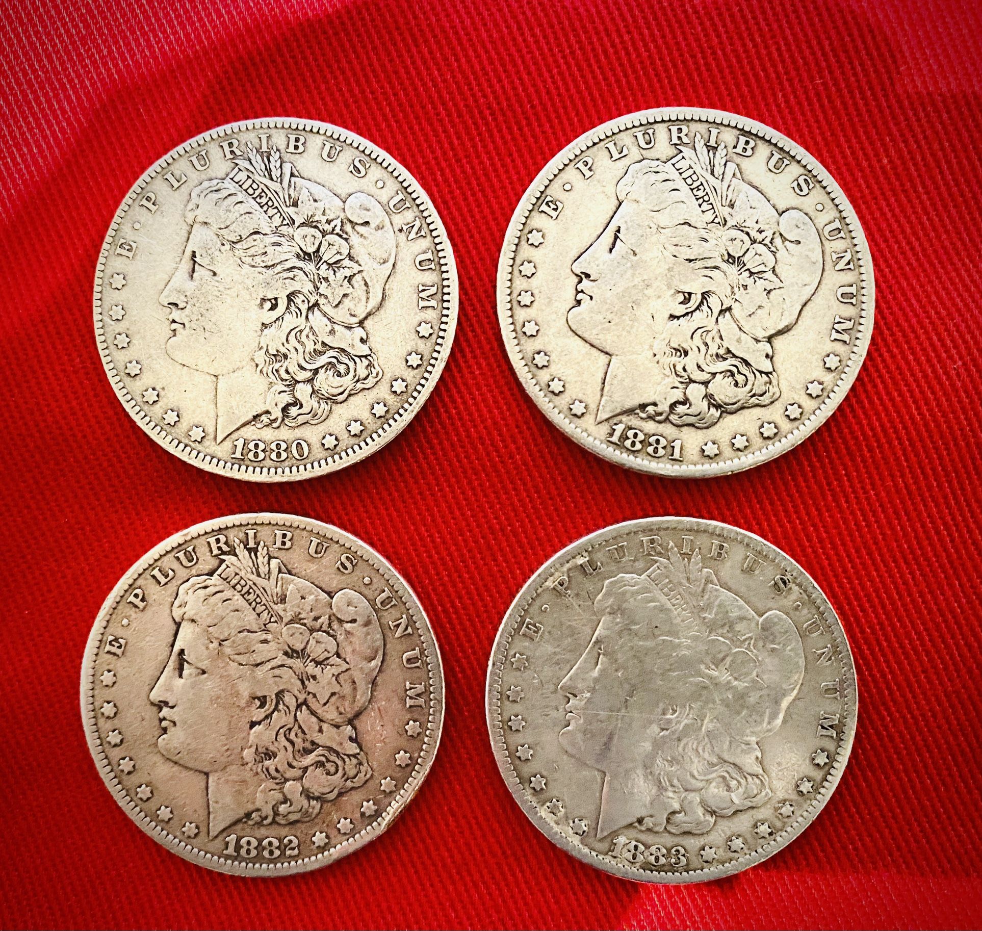 Four Morgan Silver Dollars From Early Eighteen Eighties