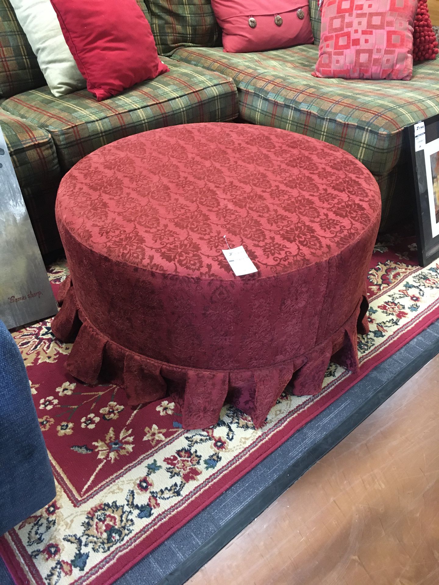 Red ottoman with pleated skirt