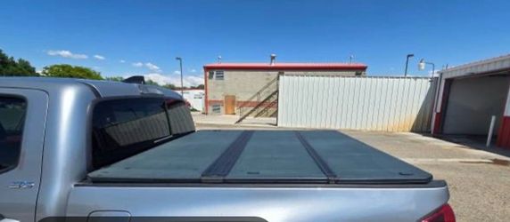(OEM) hard tri-fold tonneau cover for the 3rd Generation (2016–2023) Toyota Tacoma