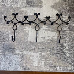 Black wrought iron wall hook rack very sturdy