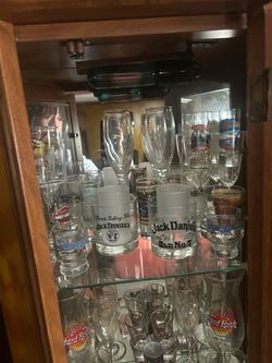 Old glass shot glasses and beer bottles and cups
