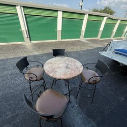 Wrought Iron, Marble Top Table With Four Swivel Bar Stools. 