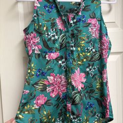 Teal background with pink and green highlights. Ideal for casual wear.  Express Sleeveless Floral Blous