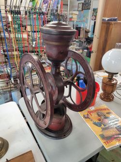 An antique cast-iron two-wheel Elgin National coffee mill by Woodruff & Edwards.