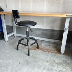 Adjustable height workbench with chair.