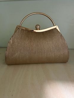 Gold metallic clutch with vertical ribbed texture