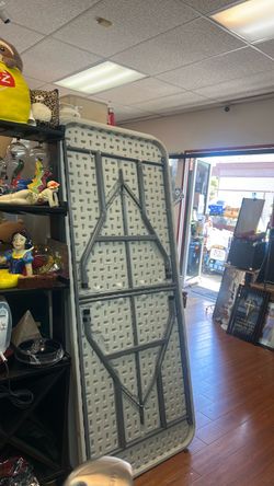 6ft plastic table  featuring a gray folding steel frame