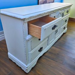 Distressed White Solid Wood Dresser. Black Hardware. 7 Drawers. 18 inches deep by 68 inches 