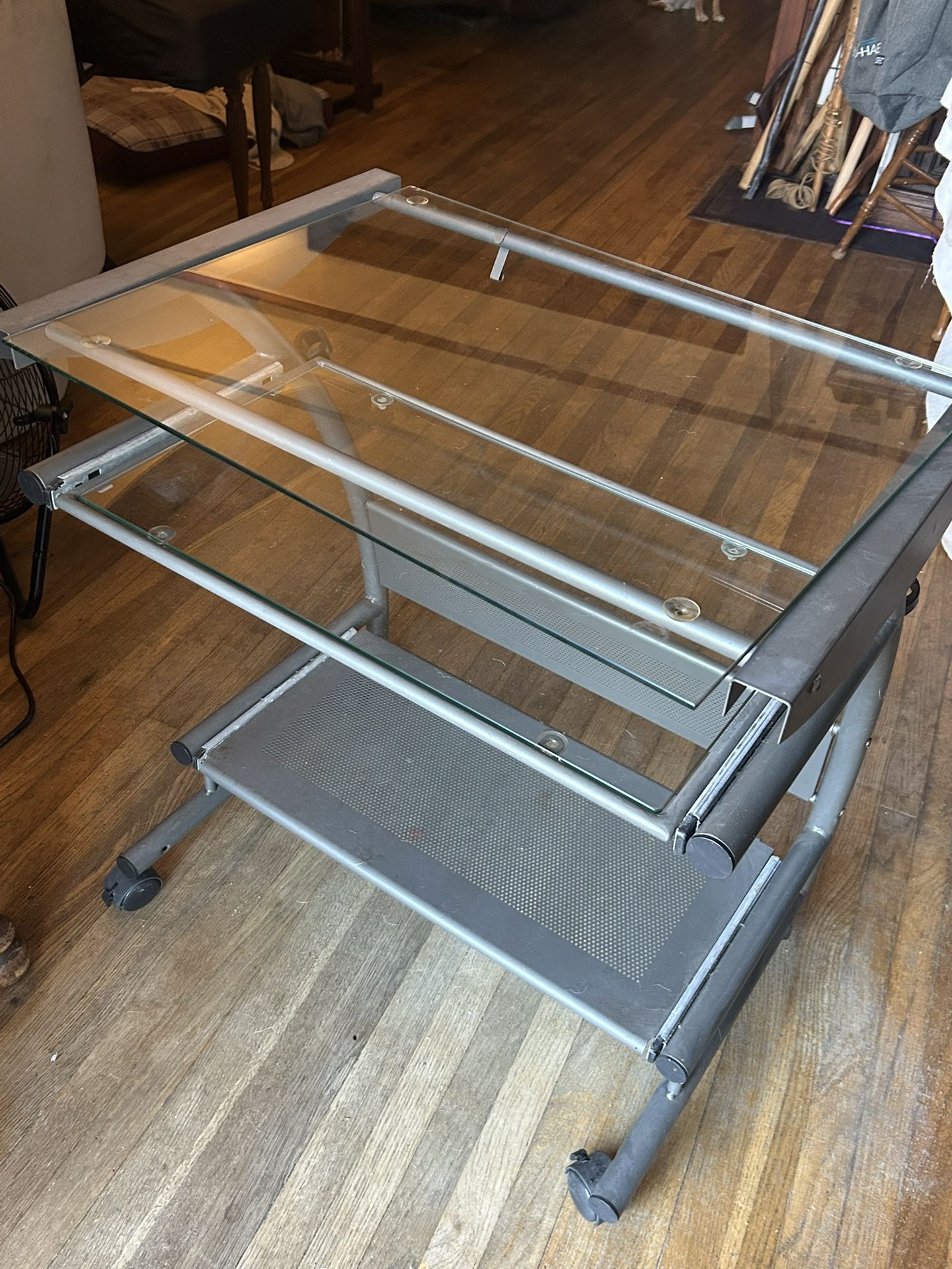 Modern style glass computer desk with a metal frame and sliding keyboard tray 