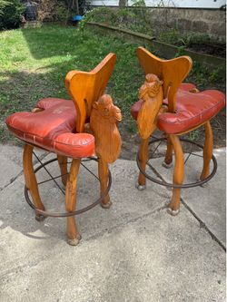 Pair of hand-carved camel bar stools