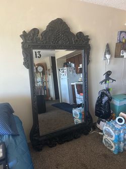 83“ x 45“This ornate, black floor mirror resembles Louis XV-style designs with a carved resin 83” x 45”