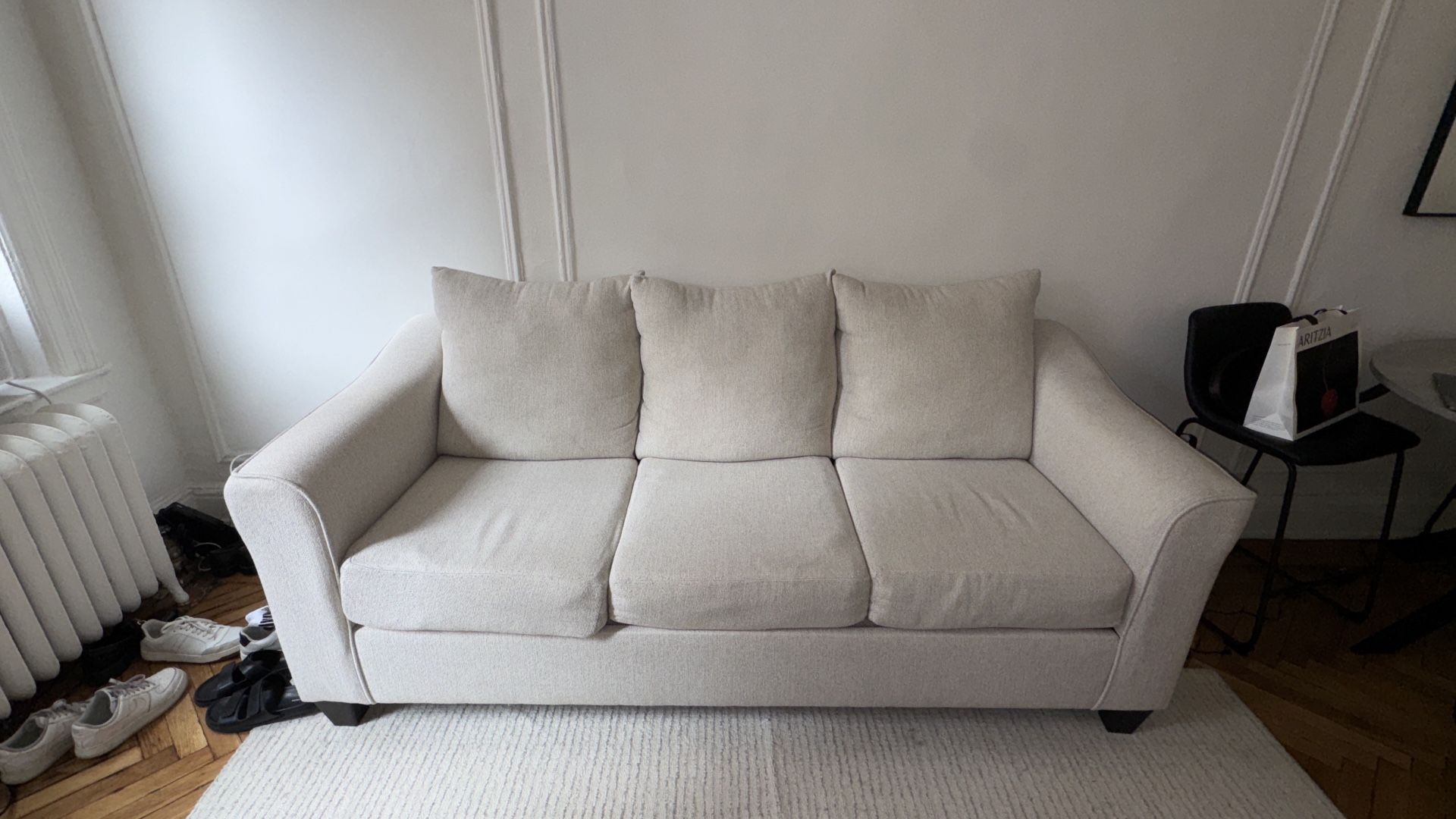 Beige three-seater sofa