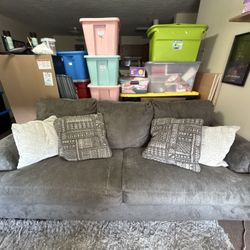 Grey sofa couch with pillows