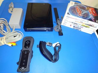 Nintendo Wii console and 6 games. Works great, plug in and play.