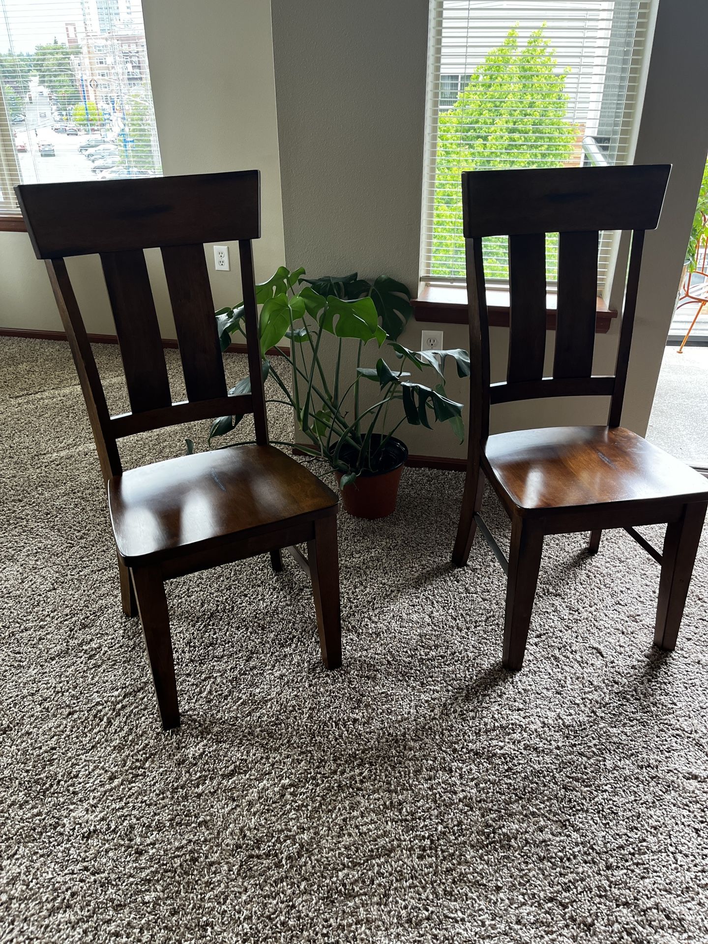 Two solid wood dining chairs