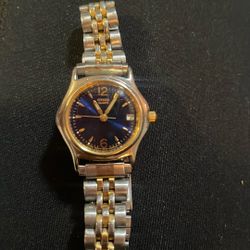 This is a vintage Citizen Quartz women's watch with a two-tone stainless steel bracelet and a blue dial. 
