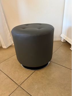 Faux gray ottoman with chrome swivel base