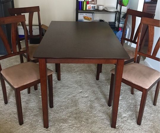 Dining Table- set of 4. Used for 2 months only. Cushions in great shape- no wear & tear.
