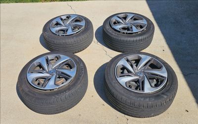 4 tires with rims and hubcaps 215/55R16