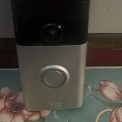 Used Ring door bell camera works great updated ready to set up comes with wall mount plate and charging cord asking 35