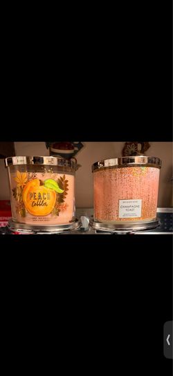 Bath and body works 2 candles brand new. Peach cobbler and champagne toast.