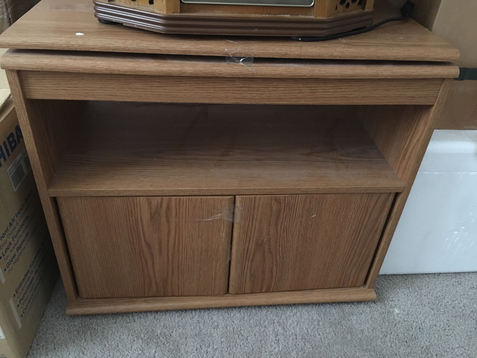 Tv stand, has marks from tape. Swivel top