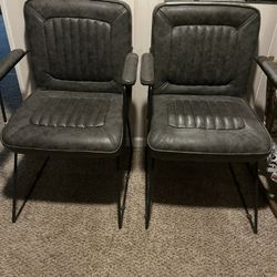 Two Gray Vinyl Cushioned Chairs With Iron Legs