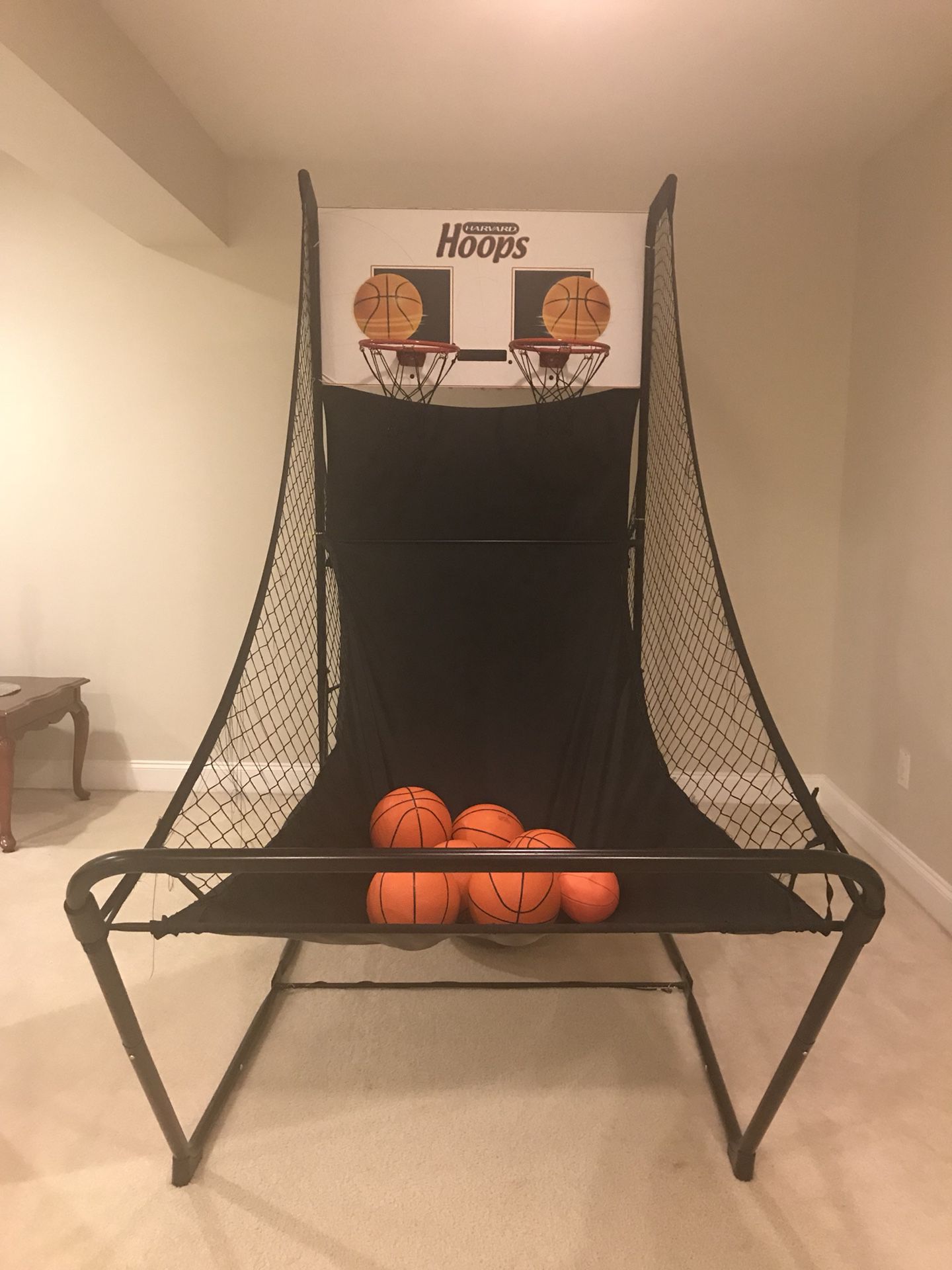 Arcade basketball hoop and air hockey table