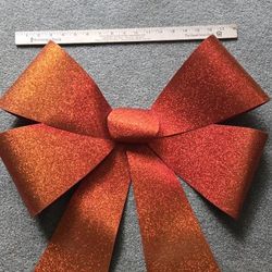 Super size reddish orange weather resistant flexible, REUSABLE, 18" wide
plastic bow. Holdel Nj
