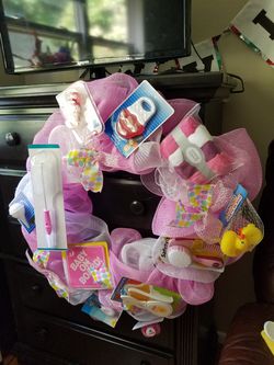 Huge baby girl wreath with items on it