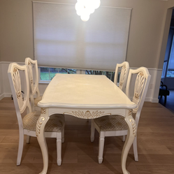 Beautiful white dining table with 4 matching chairs featuring classic carved details and an elegant, traditional design
