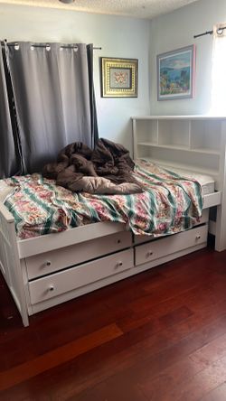 Bed has four drawers on each side and a back board for storage