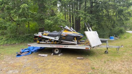 Snowmobiles and ride on ride off trailer