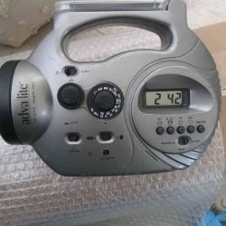 Adva Lite solar-powered radio with a flashlight and digital clock. It's designed for use in emergencies or areas with limited power access. 