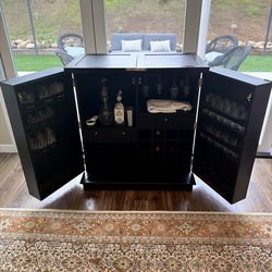 Portable and expanding bar with storage and foot rest