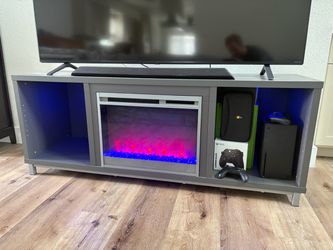 TV console with built in electric heating fireplace.