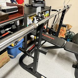 Adjustable bench, Olympic bar, bar rack and weights (2x 5lbs, 2x 10lbs, 2x 25lbs)