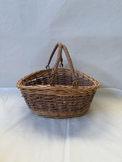 Hand-Woven Oval Wicker Basket with Swinging Handles featuring a Two-Tone Design with Natural Light Brown and Darker Accents