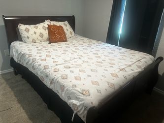 Queen bed with mattress and bedding