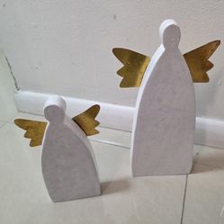 Set of 2 primitive angel figures from DEMDACO, one measuring 14"H x 5"W, and the other 10"H x 4"W.