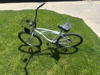 This is a like new adult beach cruiser with basket and bell