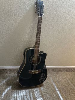 Black de Rosa 12 string guitar signed by Los del puerto