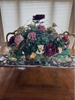 Silk flower arrangement and table runner