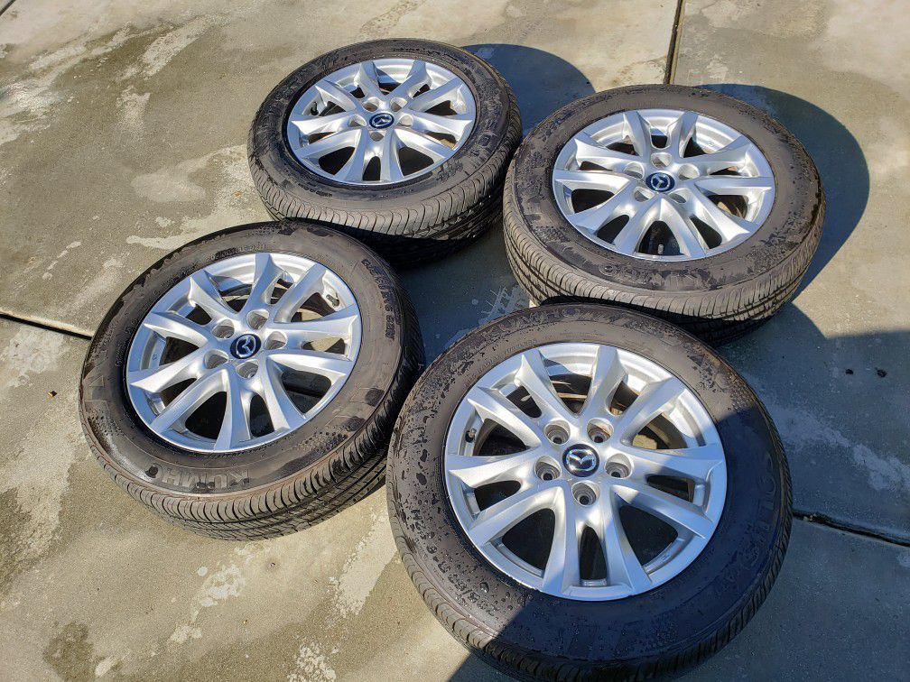 Mazda rims. New tires 205/65/16. Will fit other brands