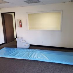 Exercise mat, 12' long x 79 inches, 1 1/2 inches thick. Solid blue in color.