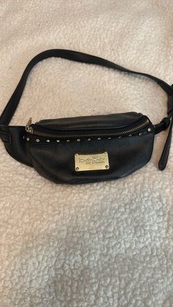 Bebe black leather strap clutch.