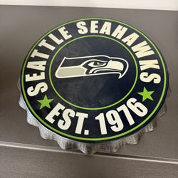 Seahawks metal bottle cap shaped sign approximately 12” x 12”